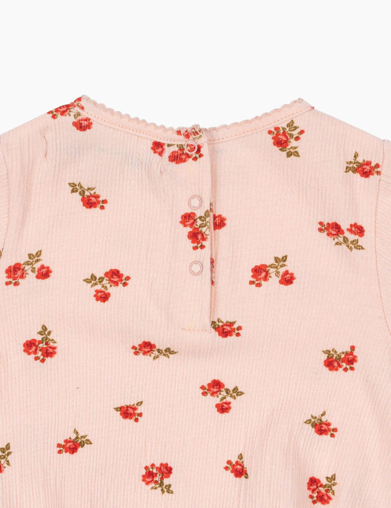 Pink garment with red floral patterns on a white background