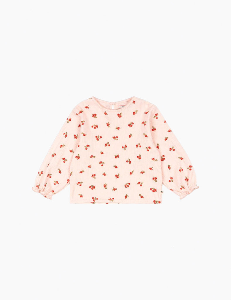 Pink long-sleeve top with small red floral pattern on a white background