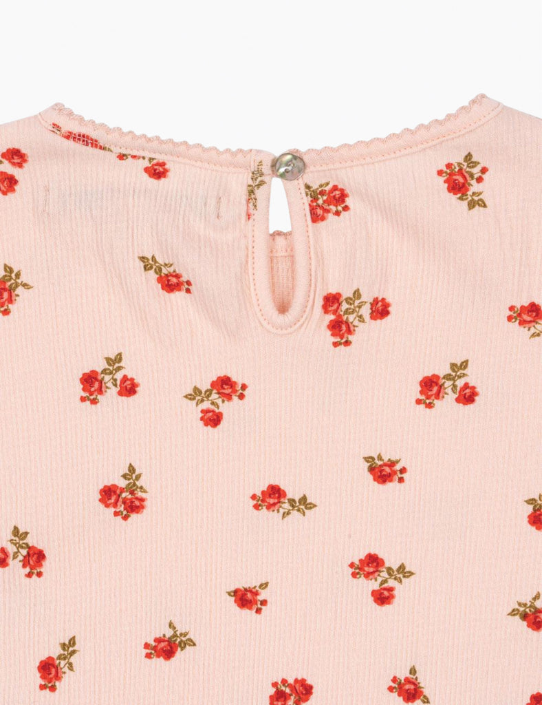 Pink garment with red floral pattern on a white background