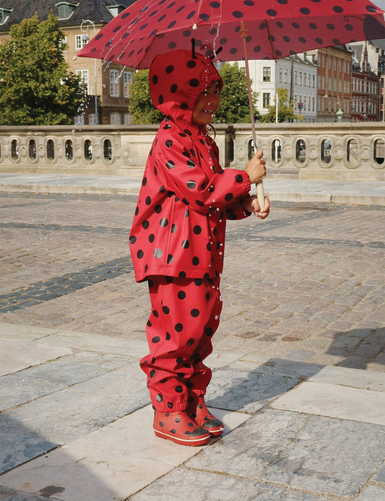 Image of child's rainboots with an allover ladybug print on a white background.