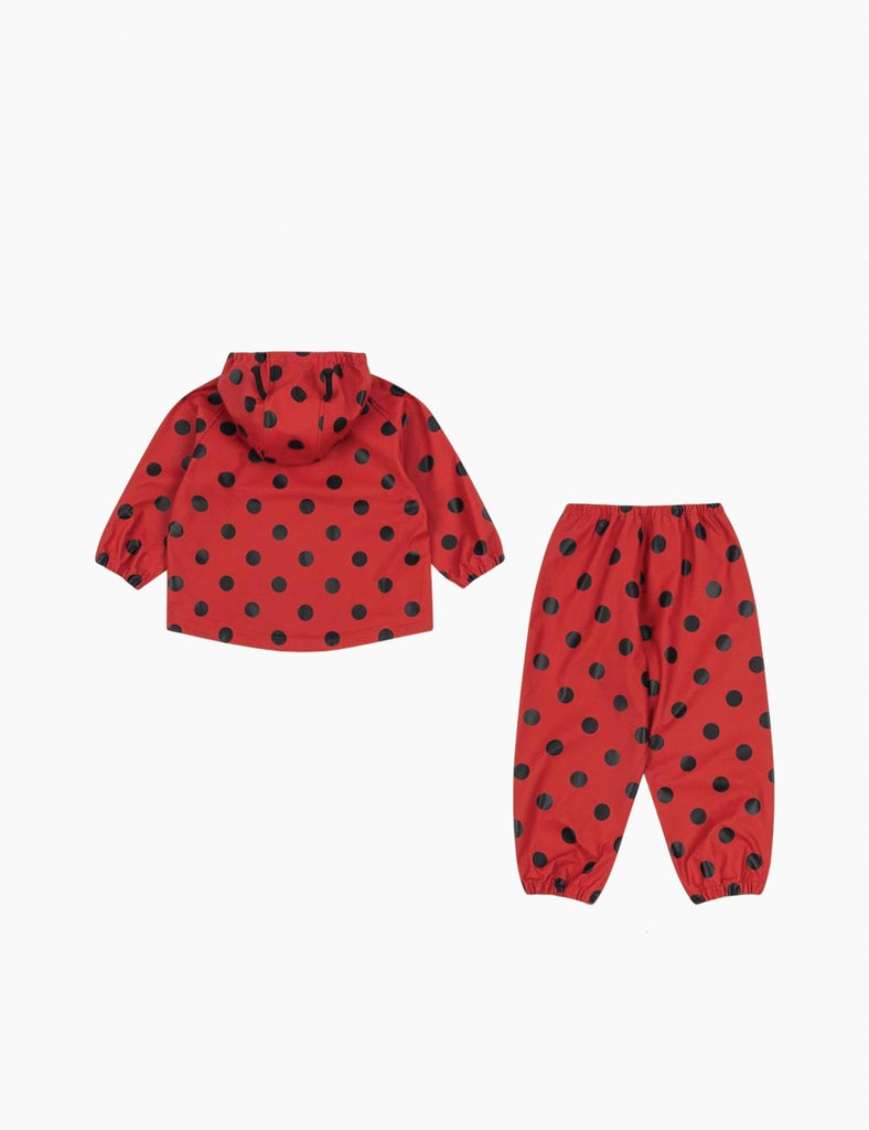 Image of a child wearing a matching hooded jacket and pant rain set. 