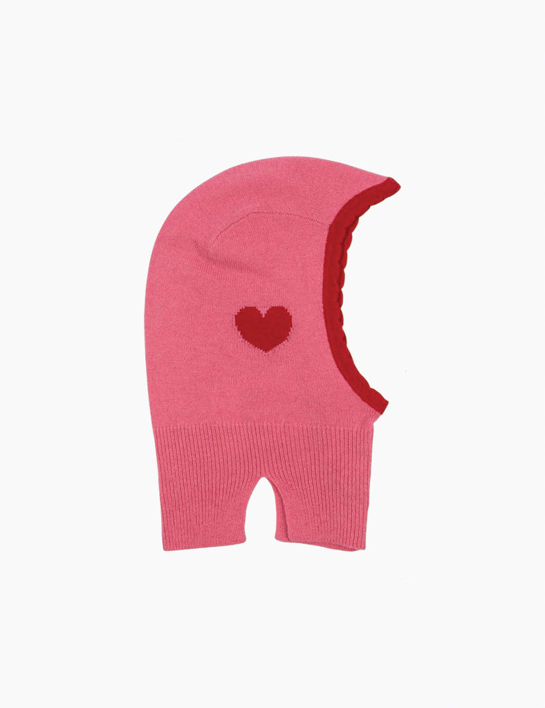 Pink knitted balaclava with a red heart on a white background