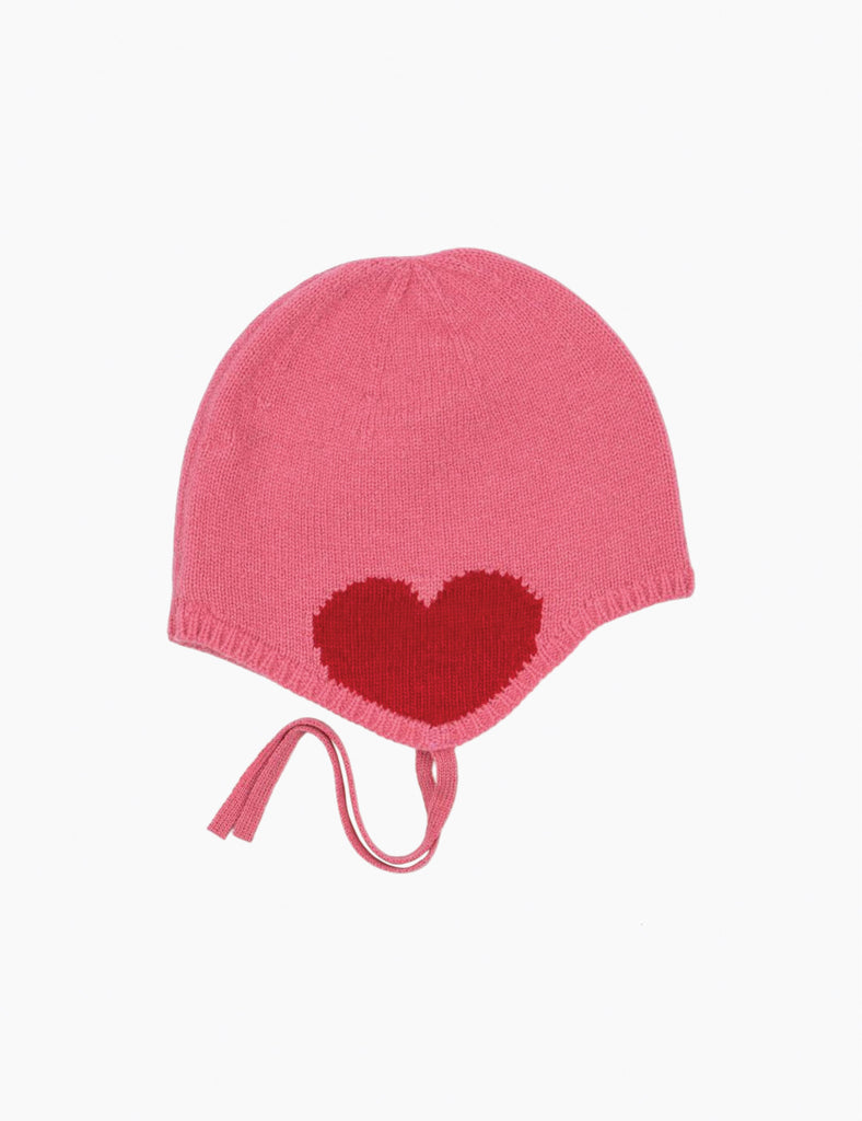 Pink knitted baby hat with a red heart on a white background