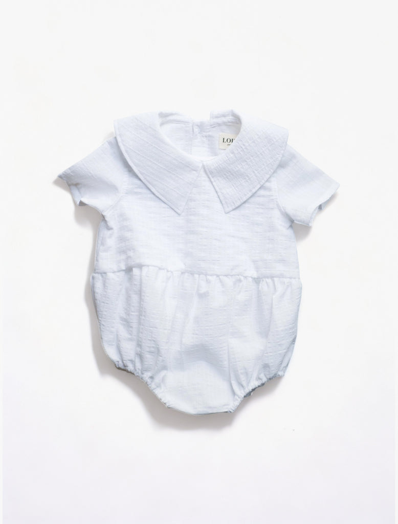 Coco Romper in White flat lay image.