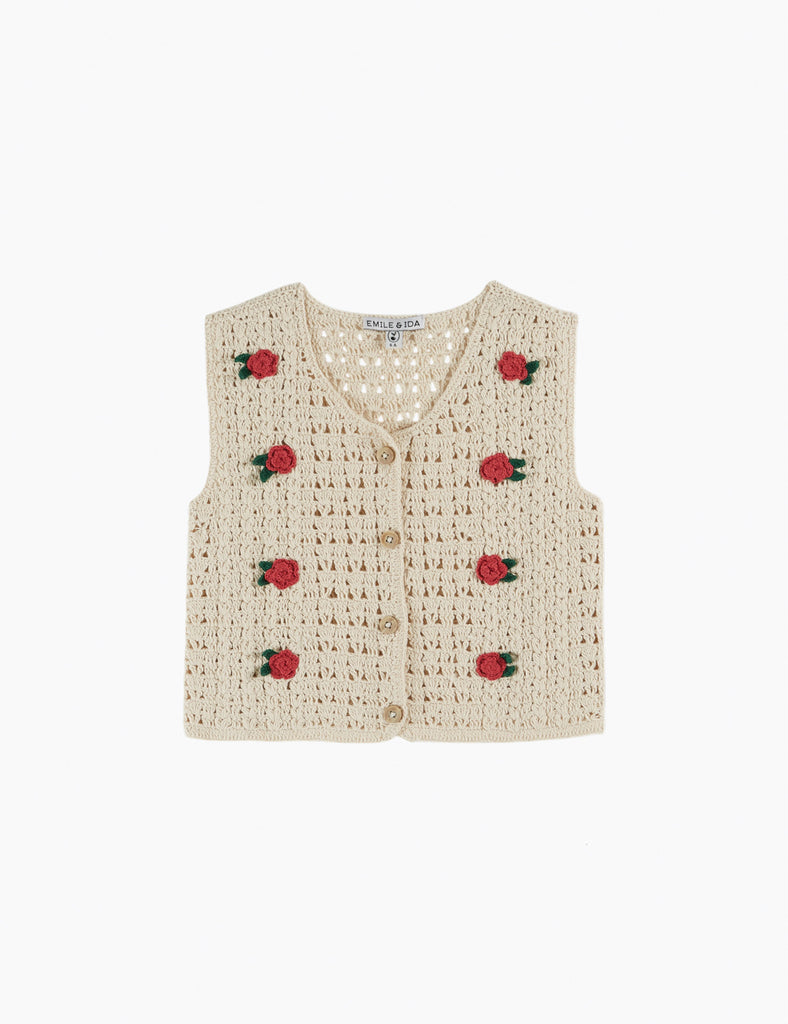 Crocheted vest with rose details on a white background