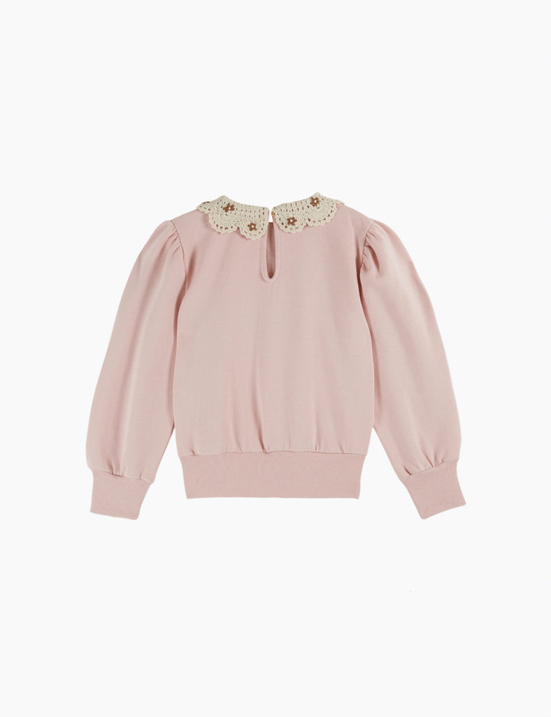 Pink sweater with a decorative collar on a white background