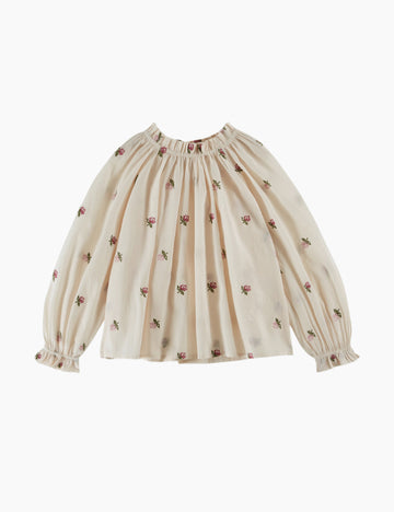 Beige blouse with floral patterns on a white background