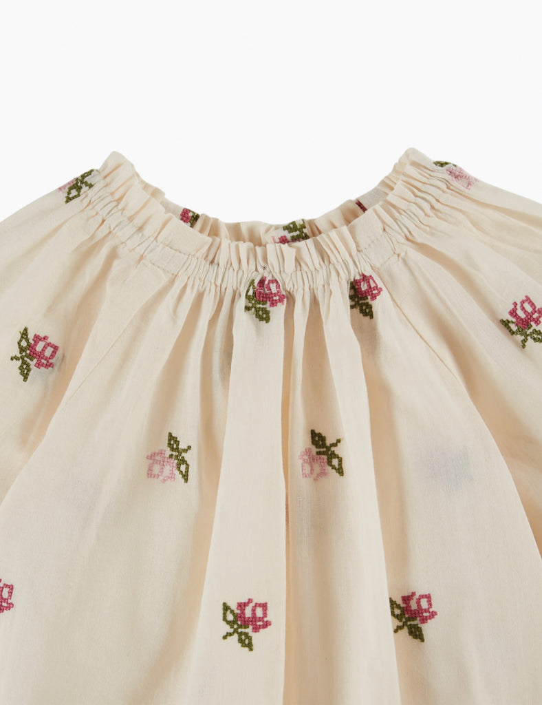 Beige skirt with floral embroidery on a white background