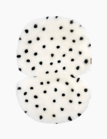 White buggy liner with black polka dots on a white background