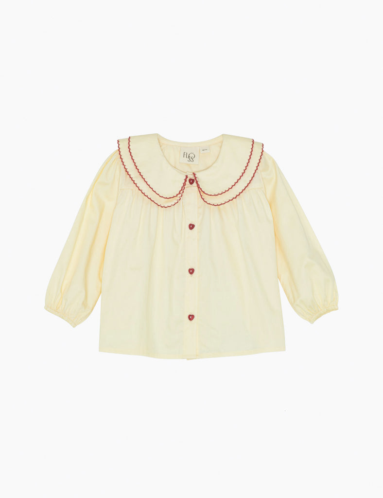 Soft white blouse with red embroidery on a white background