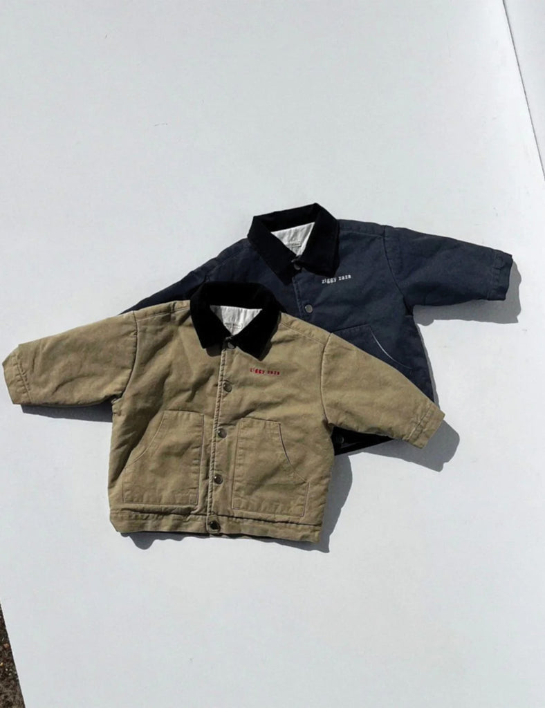 Two jackets, one beige and one navy, on a white background