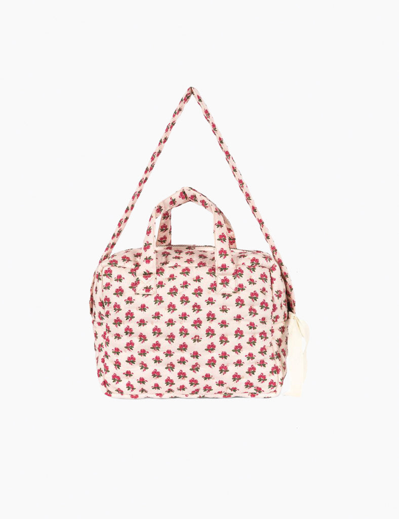 Floral patterned doll bag on a white background