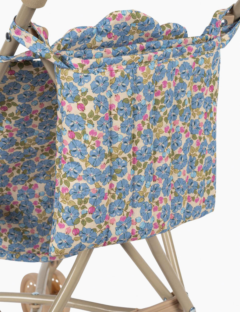 Floral-patterned chair cover on a wooden chair with floral straps.