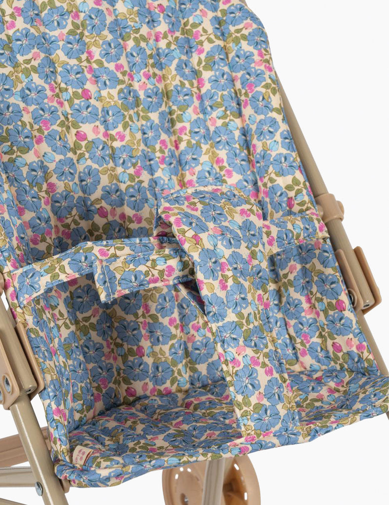 Floral-patterned cover on a wooden chair with a white background