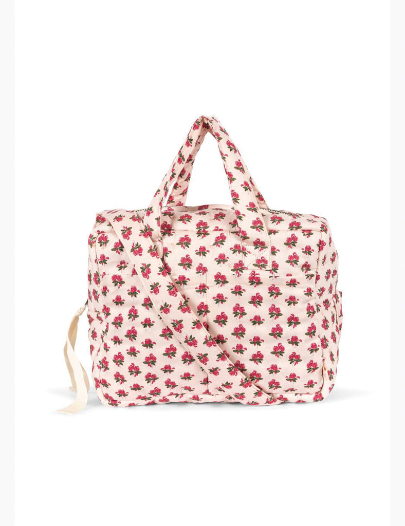 Floral-patterned doll bag on a white background