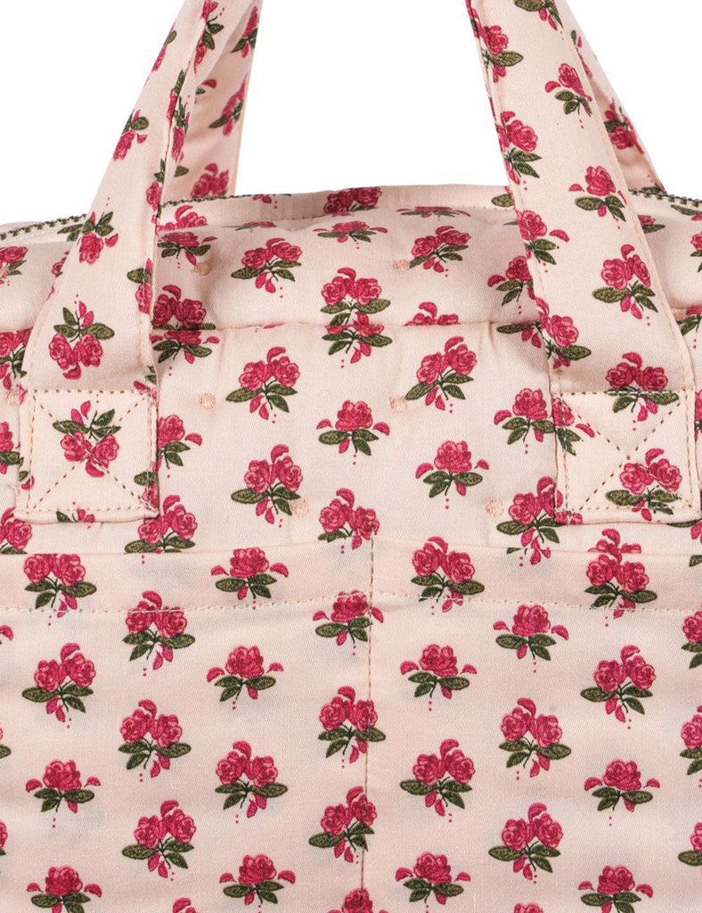 Floral patterned bag with pink flowers on a light background