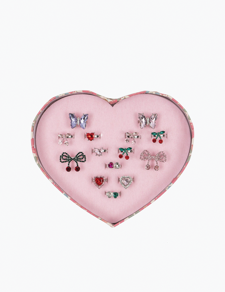 Heart-shaped pink jewelry box with various earrings on a white background