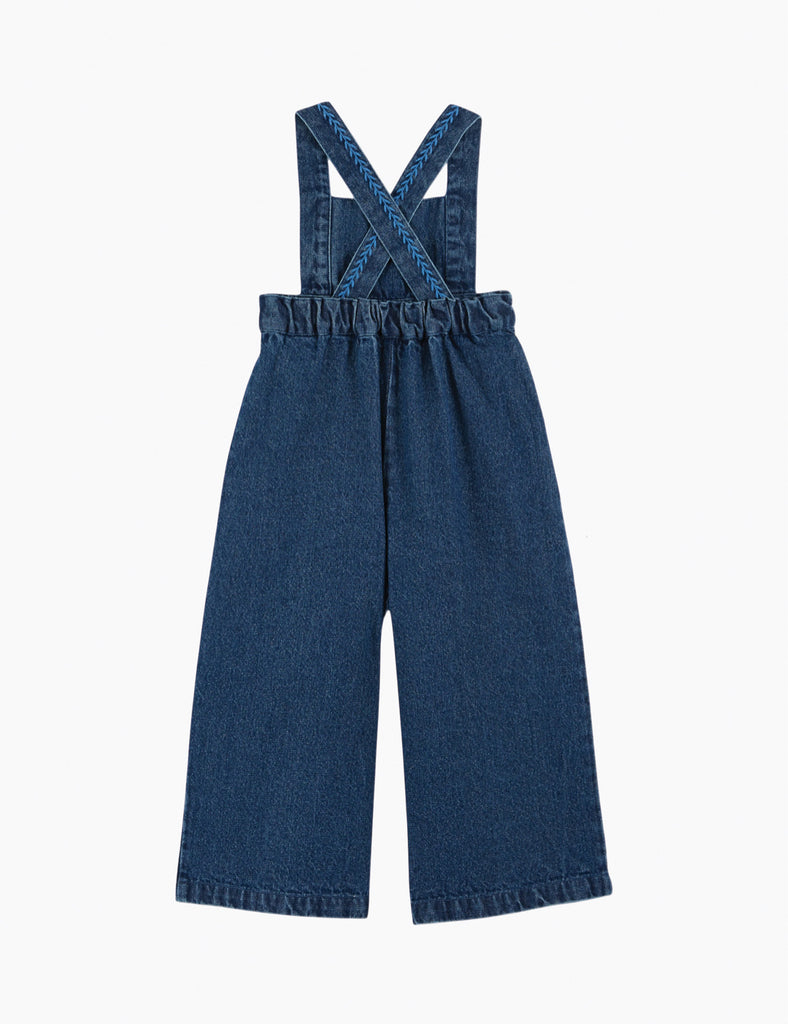 Blue denim overalls on a white background