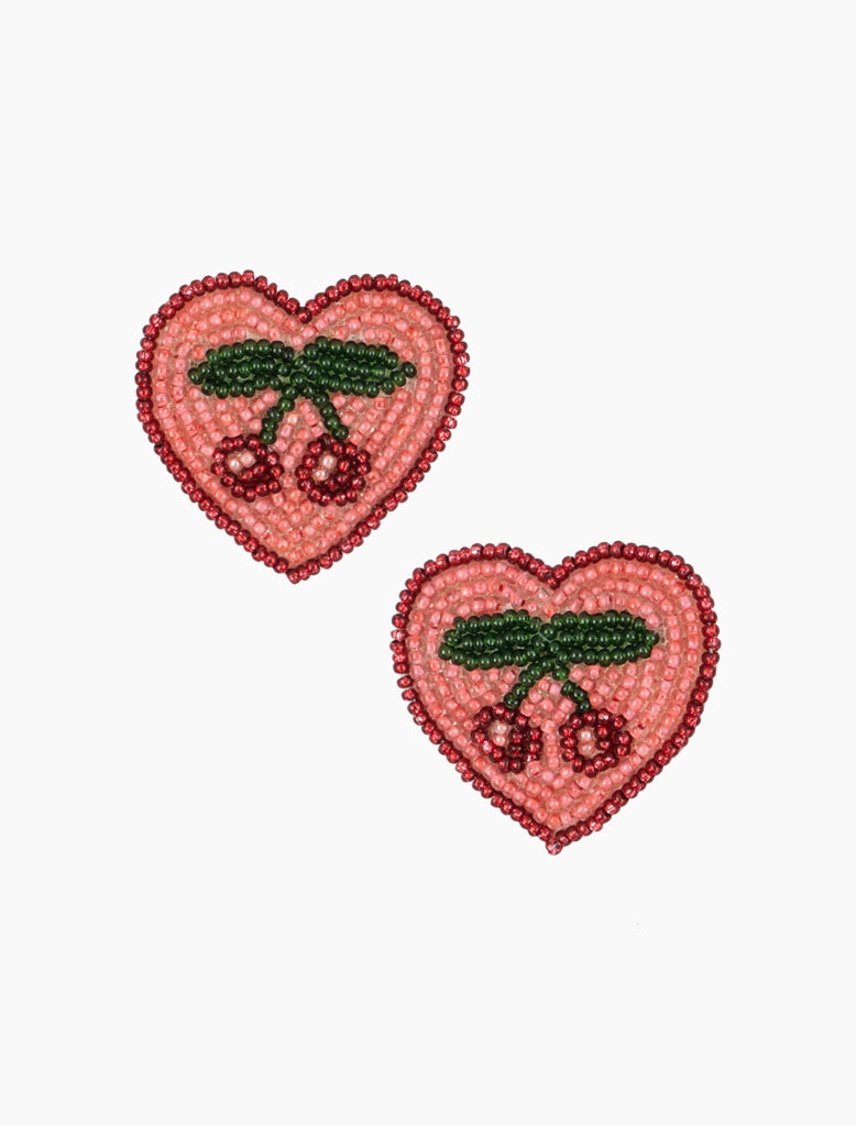 Two heart-shaped embroidered patches with cherry designs on a white background