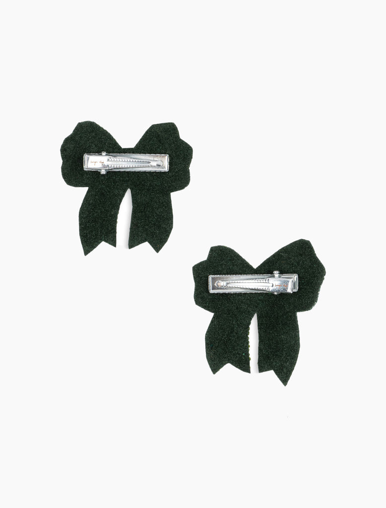 Two black bow-shaped hair clips on a white background