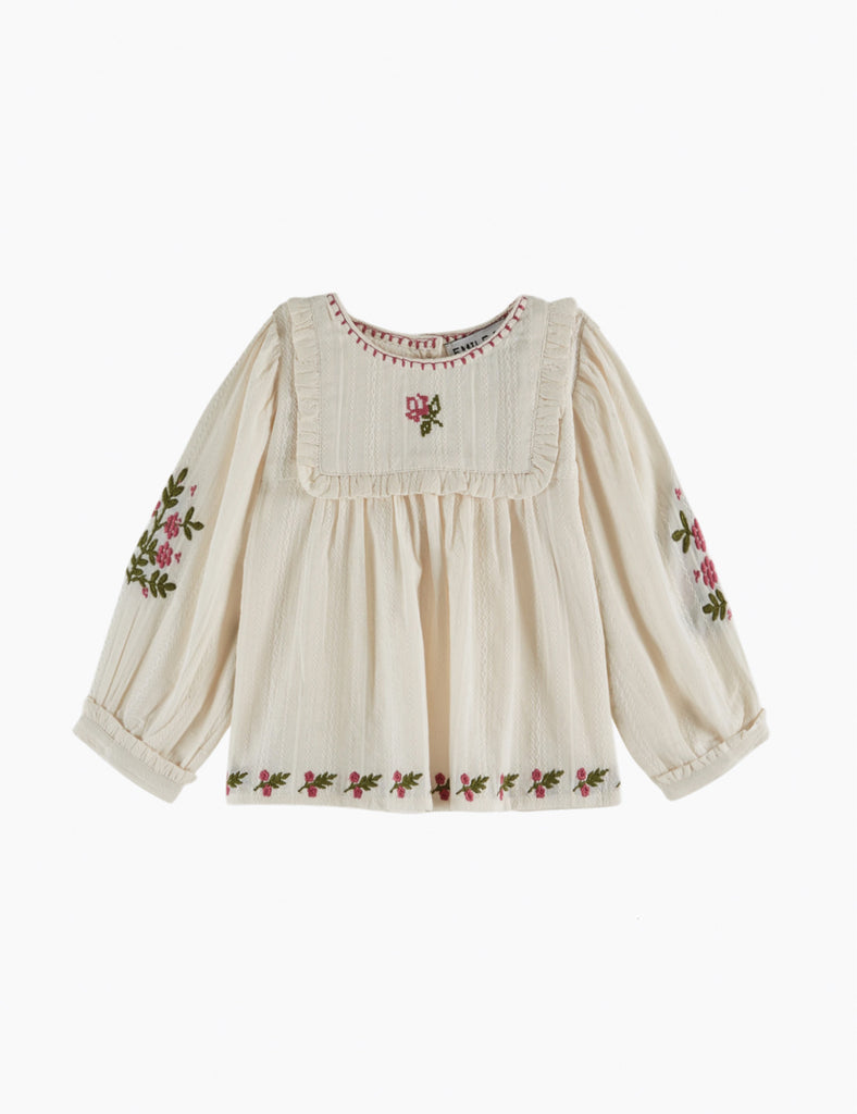 Embroidered blouse with floral patterns on a white background