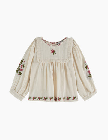Embroidered blouse with floral patterns on a white background