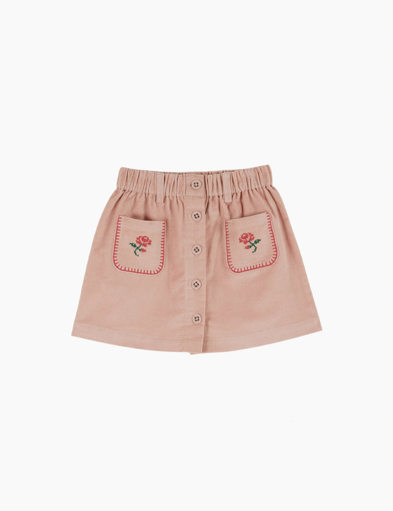 Pink skirt with rose embroidery on a white background