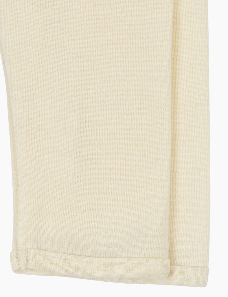 Cream wool leggings on a white background