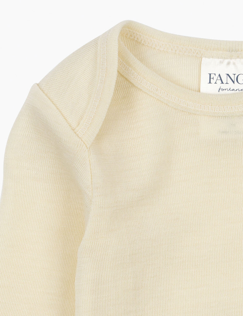Close-up of a cream-colored baby bodysuit with a visible brand label on a white background