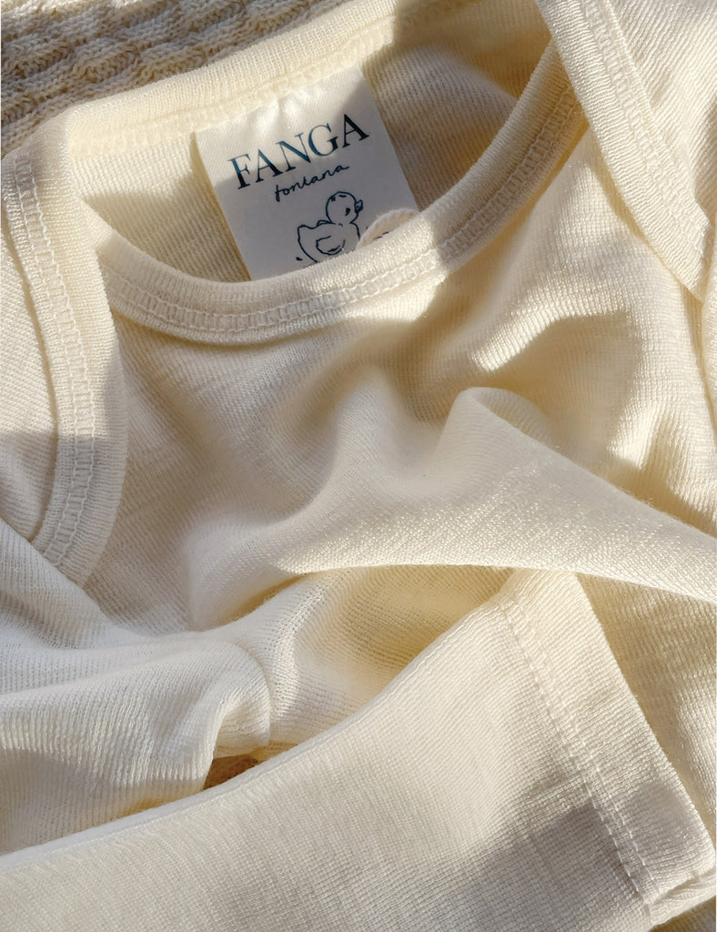 Close-up of a cream-colored fabric with a 'FANGA' label.