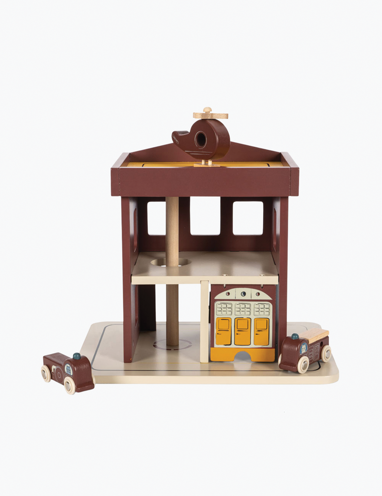 Wooden toy town with buildings and a train on a white background