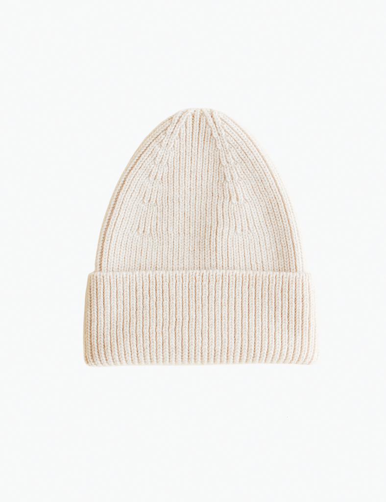 image of a cream colored beanie on a white background