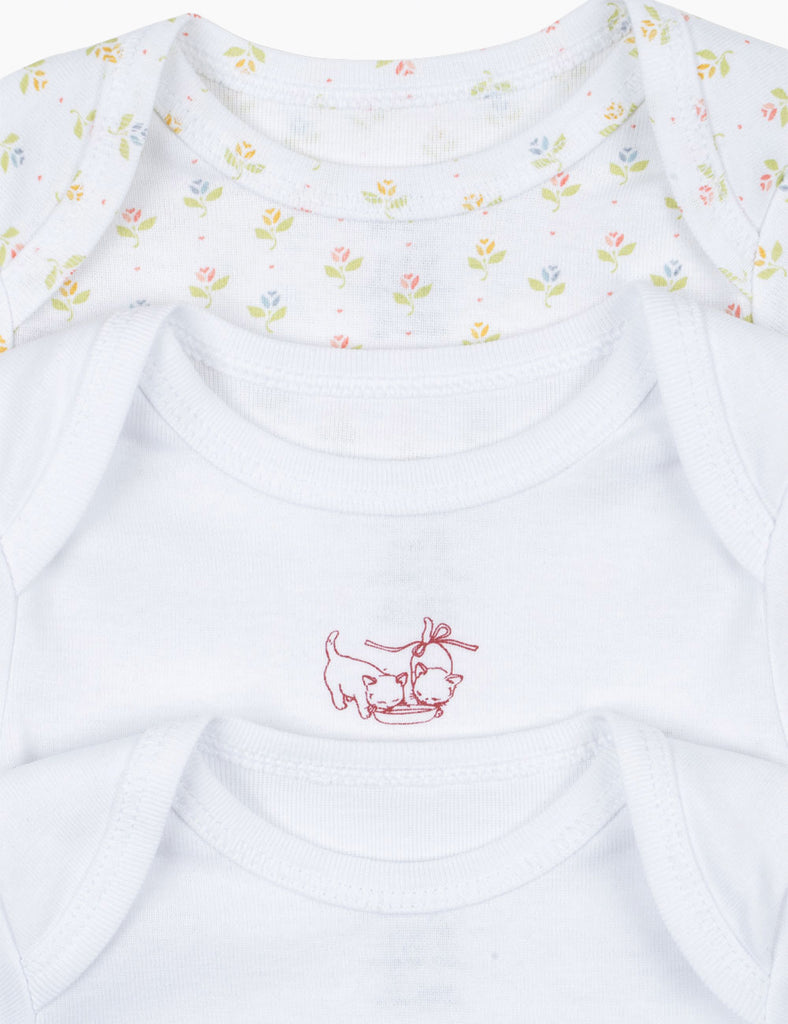 Close up of 3-pack baby bodysuits on a white background.