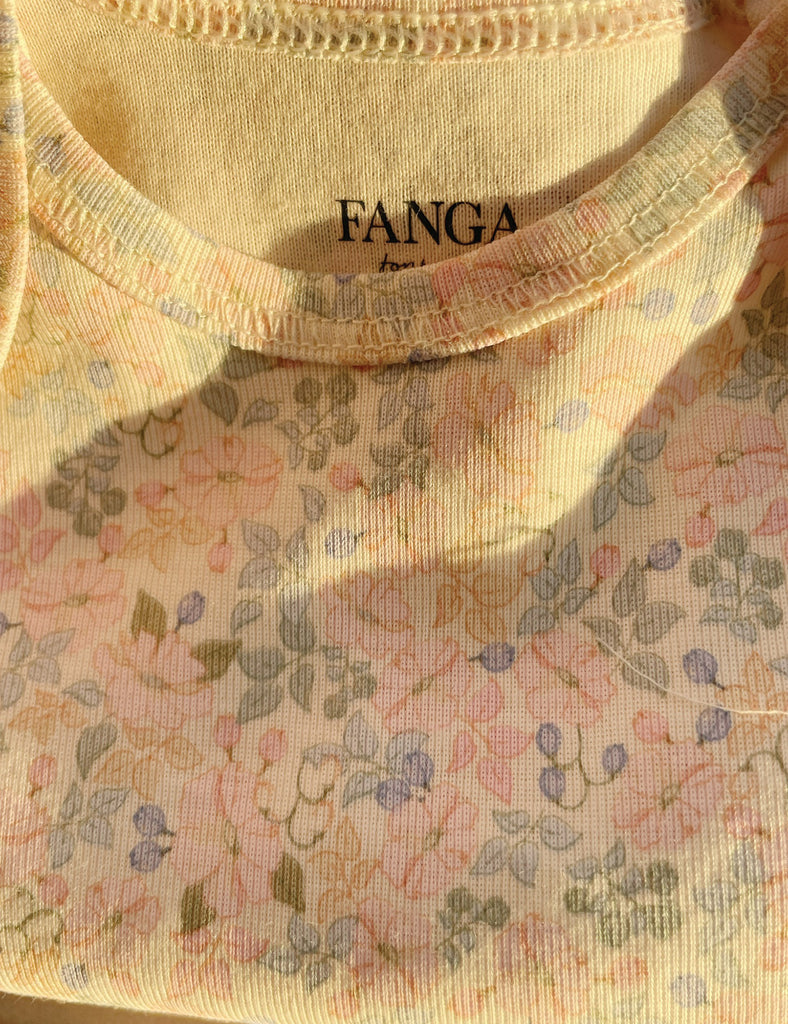 Close-up of a floral-patterned garment with 'FANG' branding.