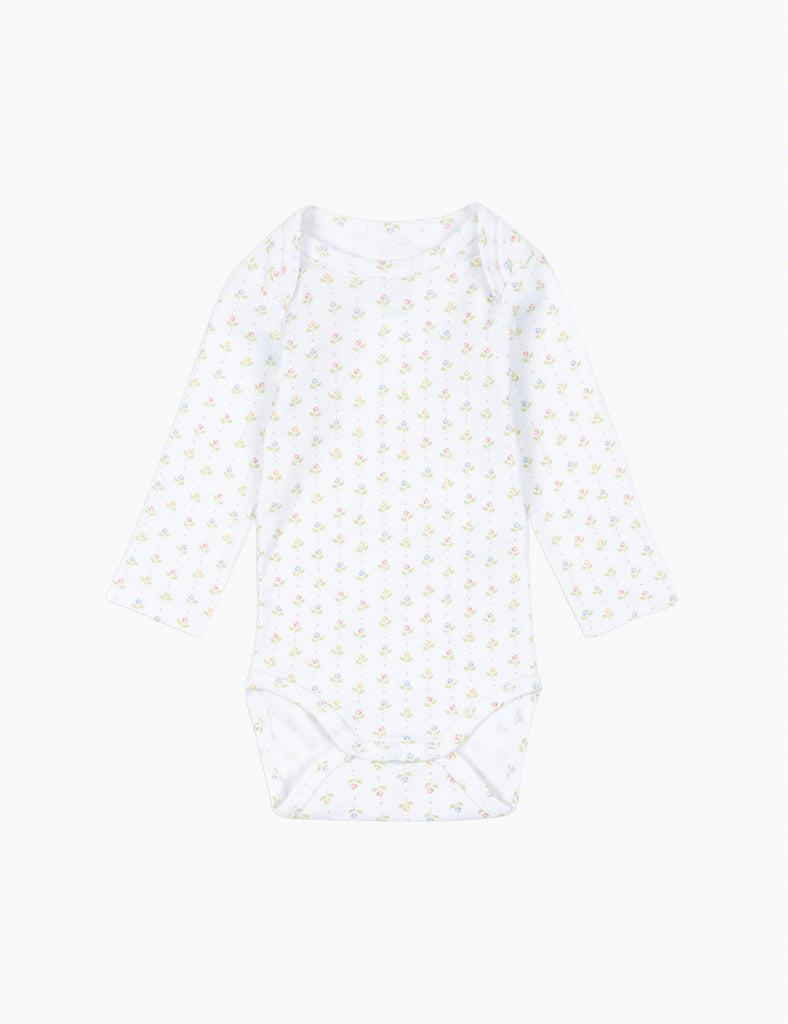 White sleeveless top with small yellow patterns on a white background