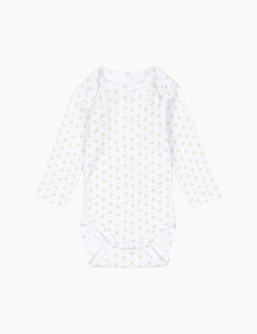 White sleeveless top with small yellow patterns on a white background