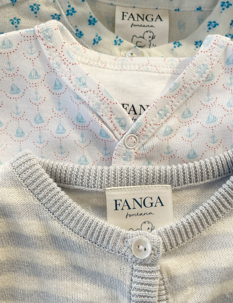 Close-up of baby clothing with 'FANGA' label on a patterned background