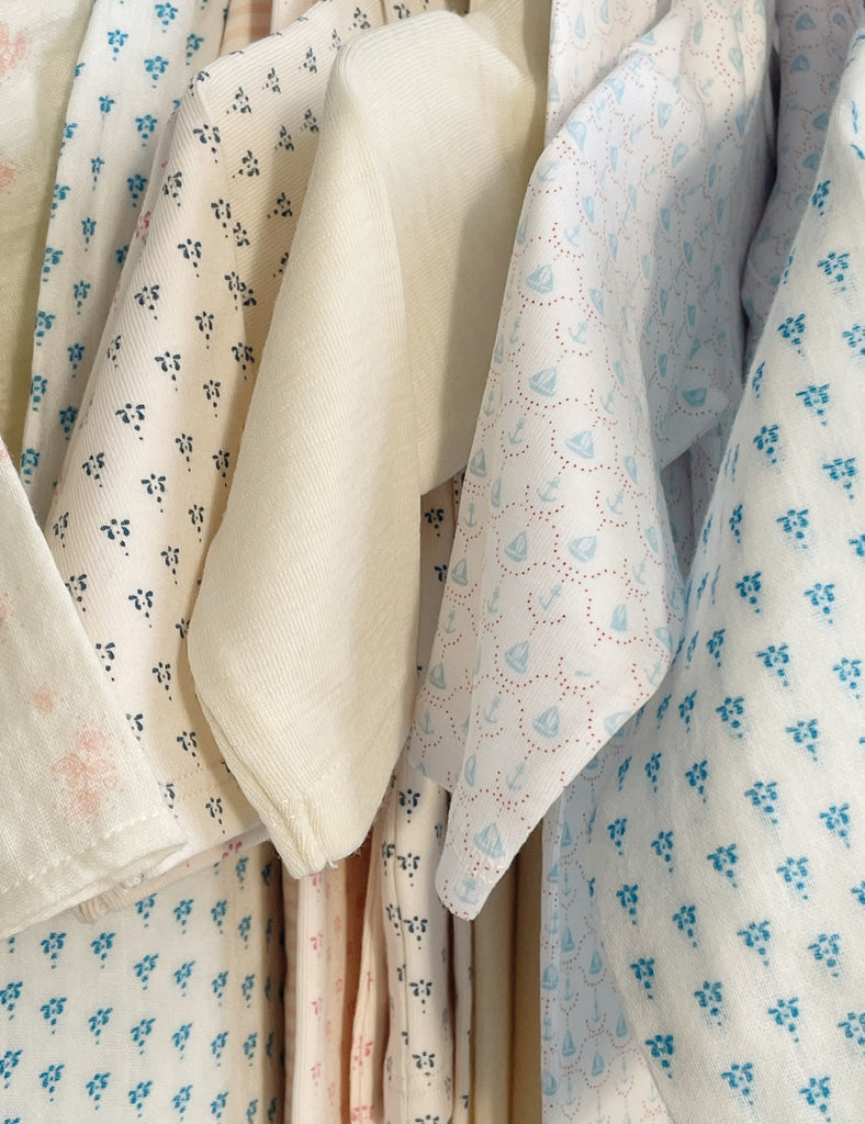 Collection of patterned fabrics hanging on a rack
