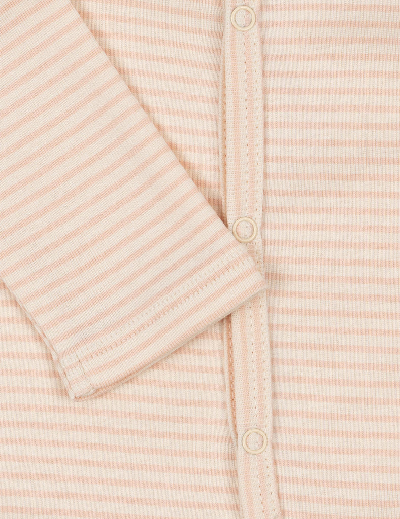 Close-up of a pink striped baby onesie with buttons.