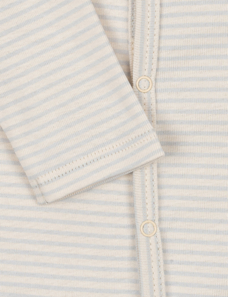 Close-up of a baby outfit with light blue and white stripes and buttons.