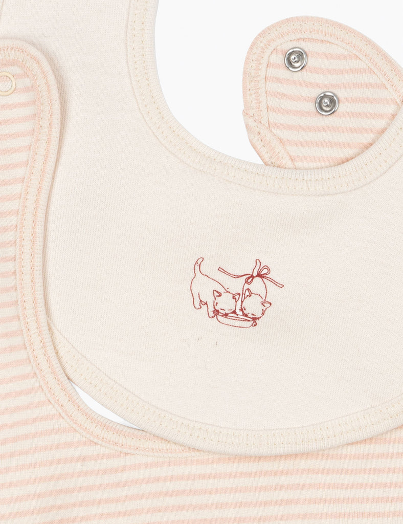 Pink baby bib with a small embroidered design on a matching pink background