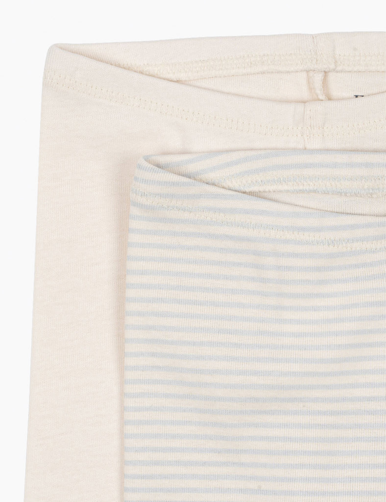 Close-up of a folded fabric with a subtle striped pattern on a white background