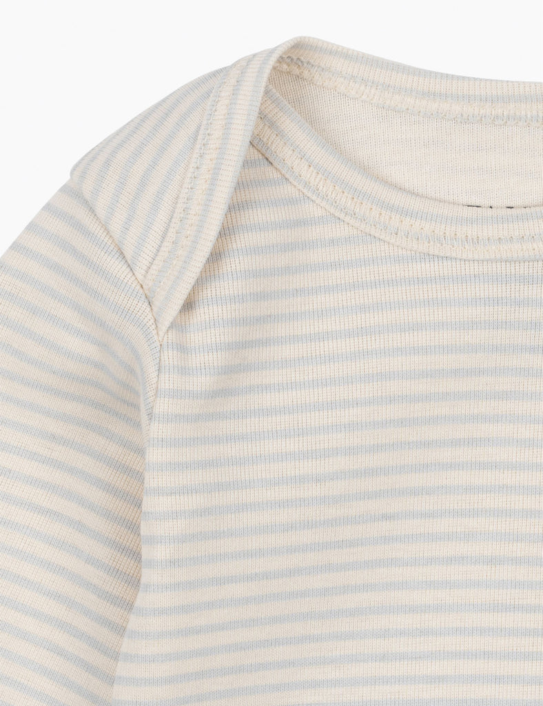 Close-up of a baby's striped shirt with light blue and white stripes on a white background