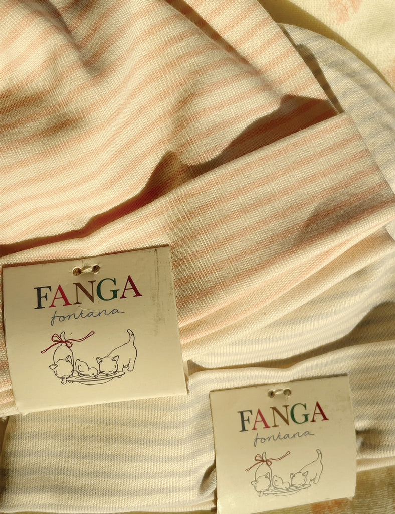 Striped fabric with 'FANGA' brand labels on a soft focus background