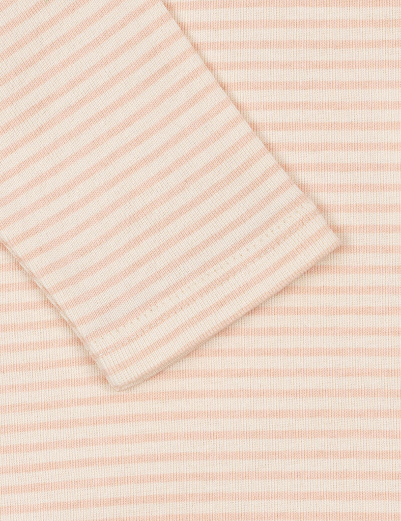 Folded pink and white striped fabric on a matching background
