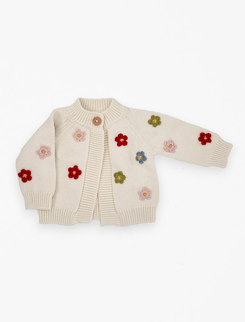 Flat image of the flower cardigan with multi colored knit flowers in cream.