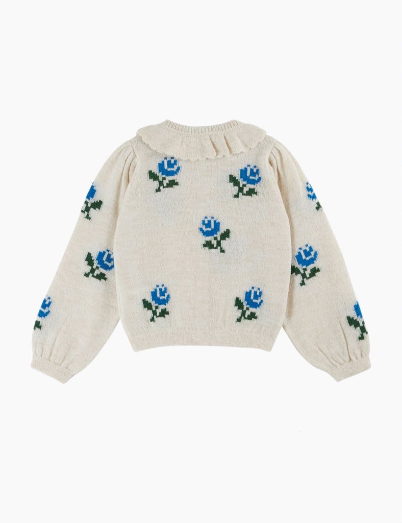 Cream-colored sweater with blue floral patterns on a white background