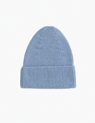 Blue knit beanie on a white background