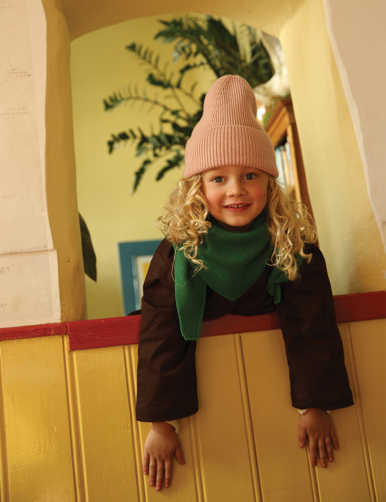 Image of a child wearing a pink knit beanie