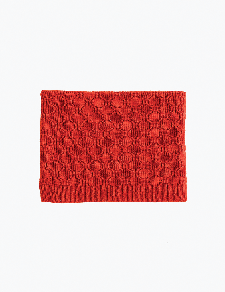 Red knitted tube scarf on a white background